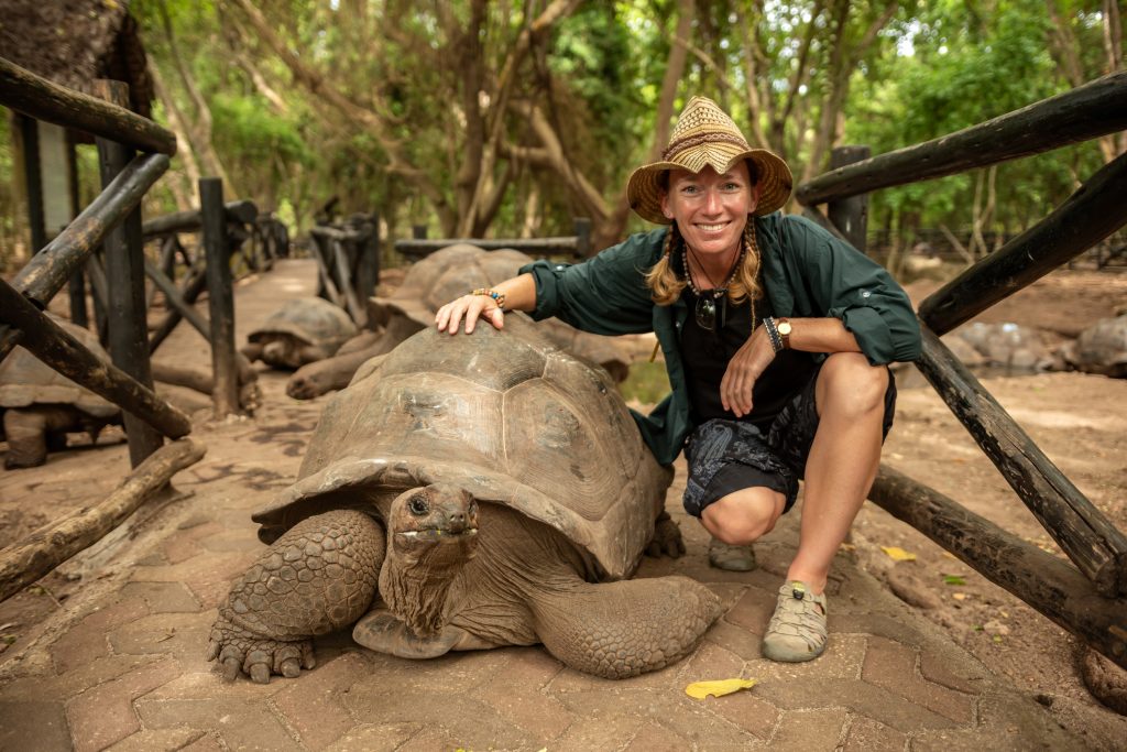 A picture of a woman and tortoise for our ranking of Inexpensive Online Zoology Degree Programs 2022